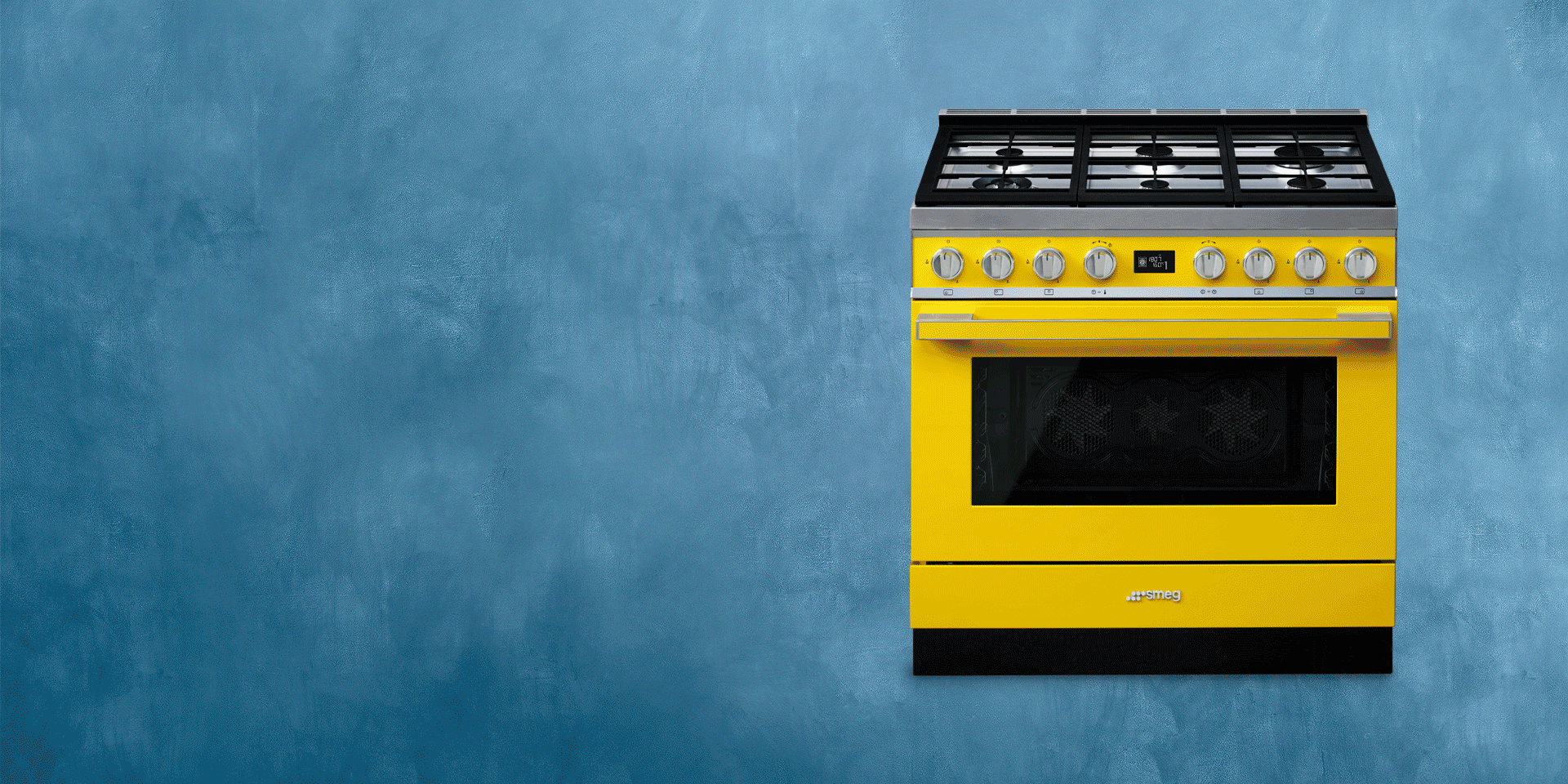 Yellow Portofino freestanding cooker photographed front view against a textured blue background