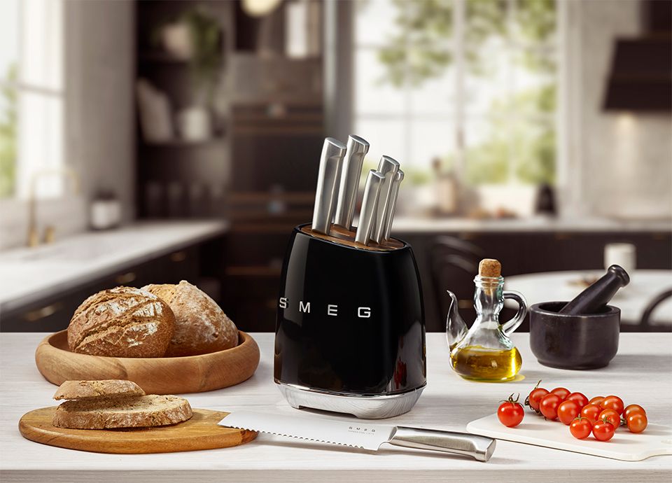 Black knife block with stainless steel knives on a kitchen countertop