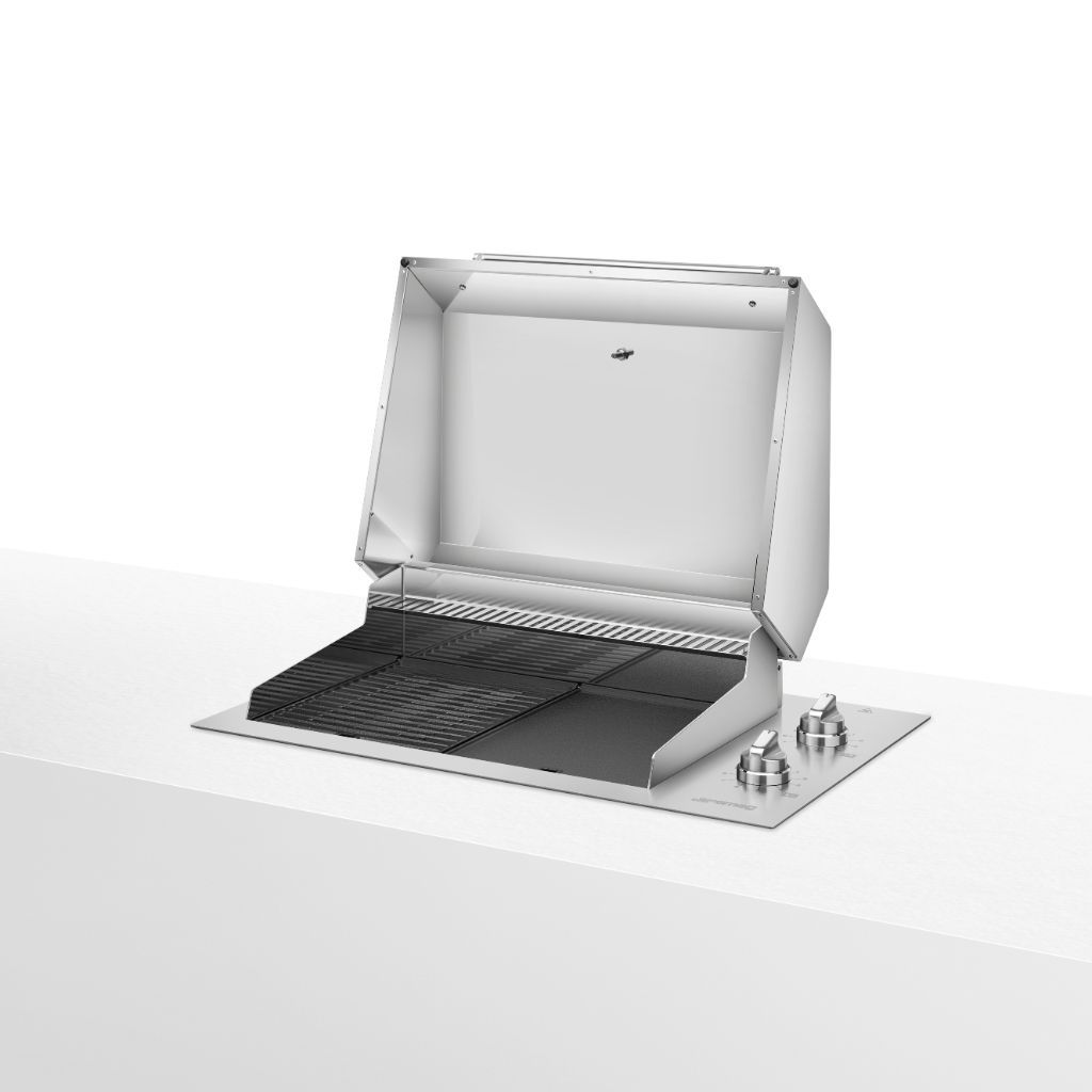 Built-in stainless steel barbecue with open lid. The cooking surface features black cast-iron grates divided into two cooking zones. On the right side, there are two round metal knobs for temperature control. The design is sleek and modern, with a polished finish and sturdy details. The appliance is placed on a light-colored countertop.