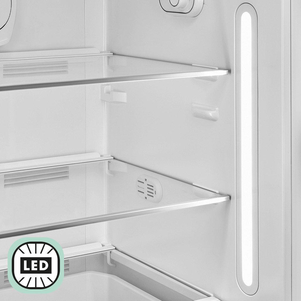 Interior of a refrigerator with glass shelves and vertical LED lighting illuminating the compartment