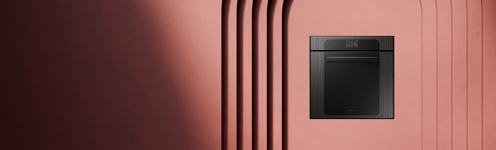 A sleek, built-in black oven installed in a terracotta-colored wall with minimalist architectural arches.